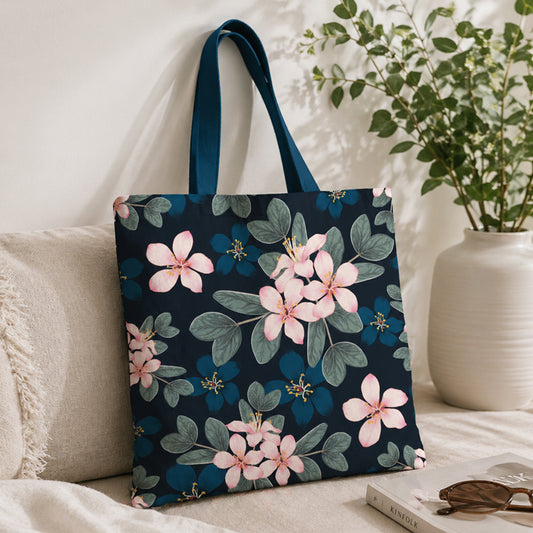 Floral-patterned tote bag on a couch with a plant in the background