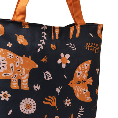 A black tote bag with orange and white animal and plant print designs, featuring deer, fish, and flowers, with orange handles.