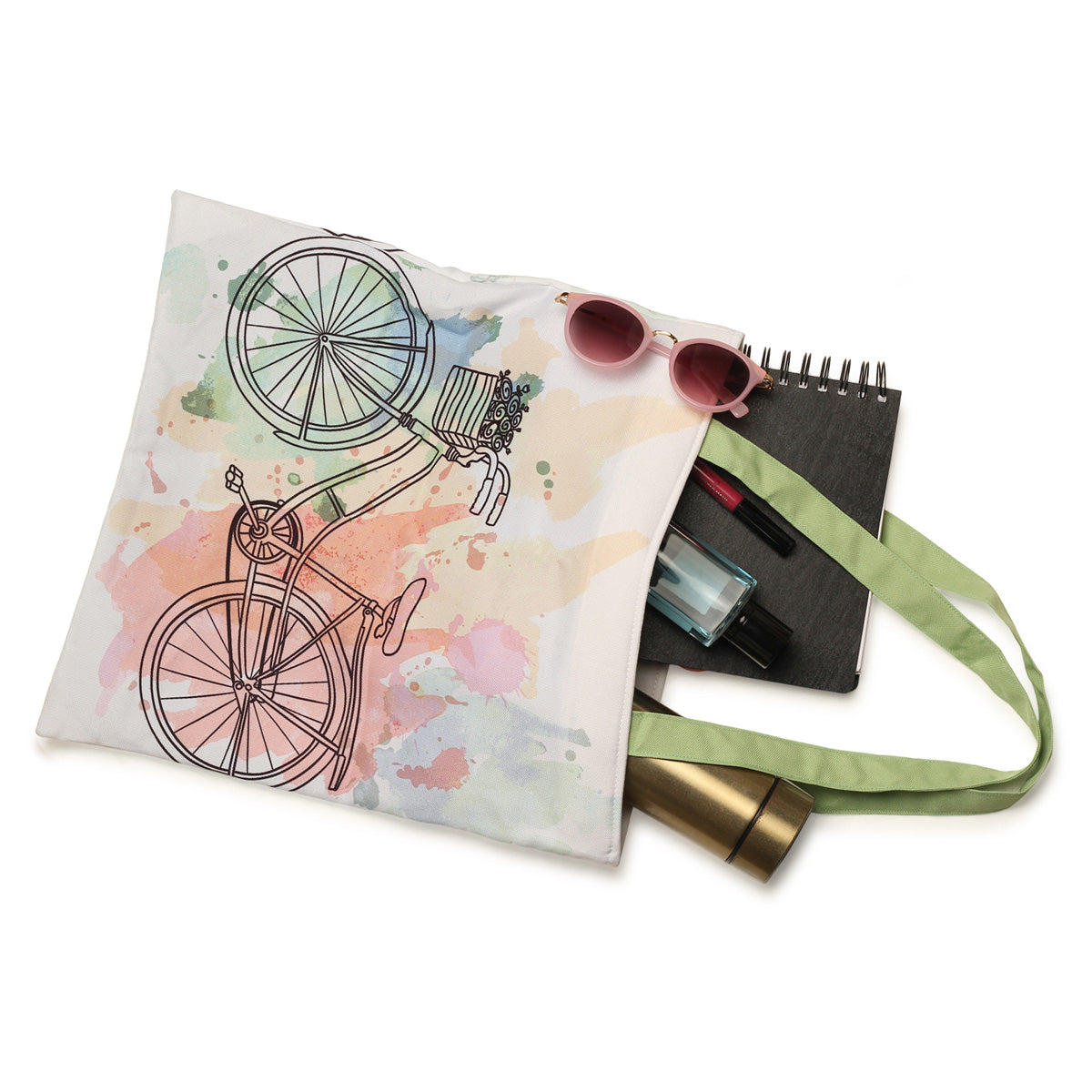 A tote bag with a colorful bicycle print, sunglasses, a black notebook, and a gold tube of lipstick.
