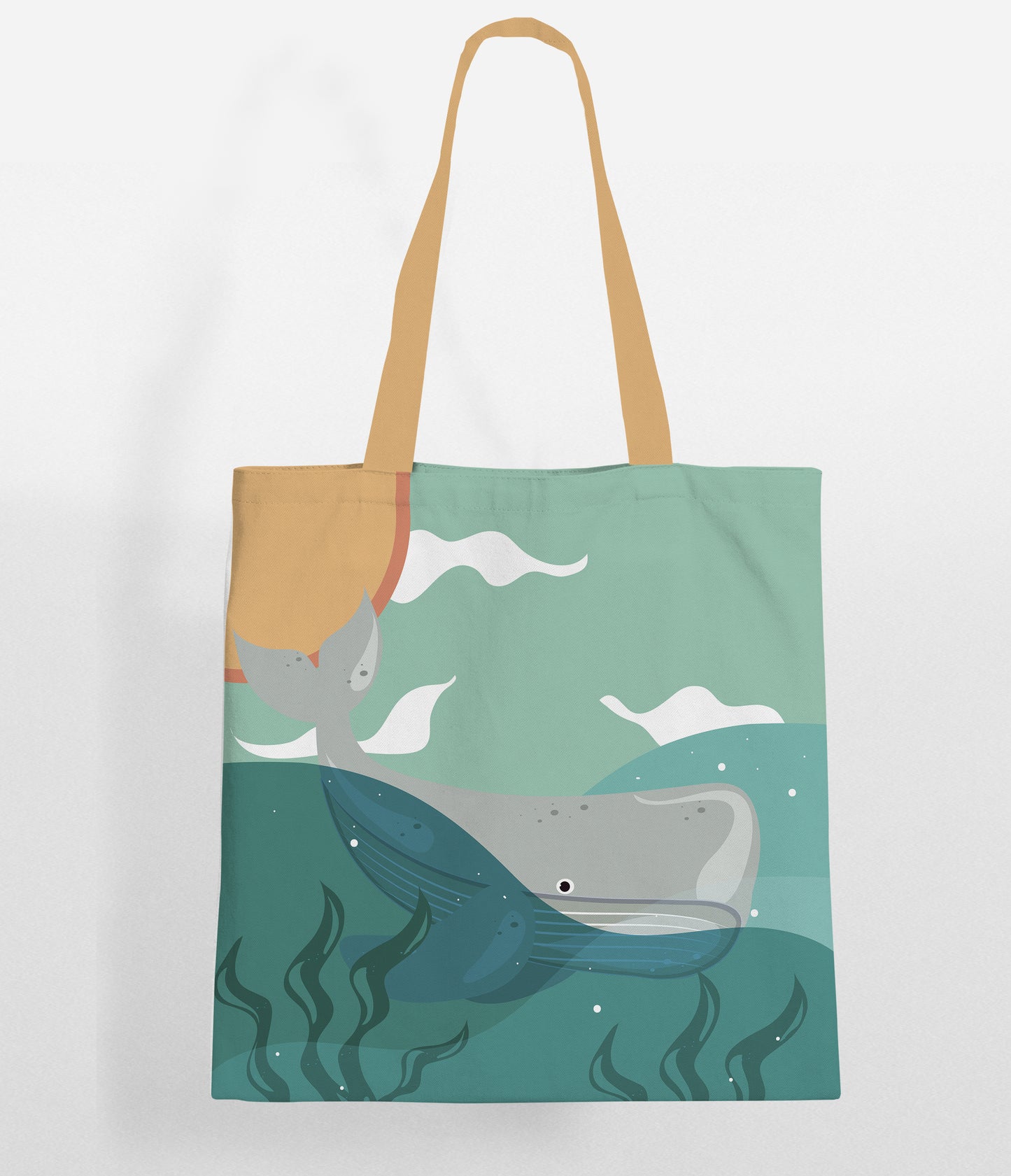 A tote bag with a beige handle and top, featuring an illustrated design of a gray whale and a narwhal swimming in teal blue ocean water with green seaweed and white waves.