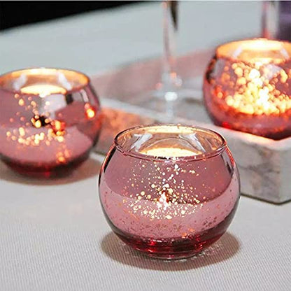 Two pink glass tealights on a tray, creating a soft and inviting atmosphere.