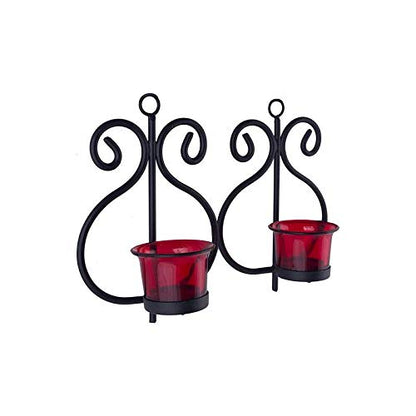 Two red candle holders with black metal accents on a wooden surface.
