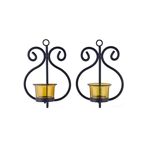 Two black metal candle holders with yellow glass, perfect for adding a warm glow to any room.