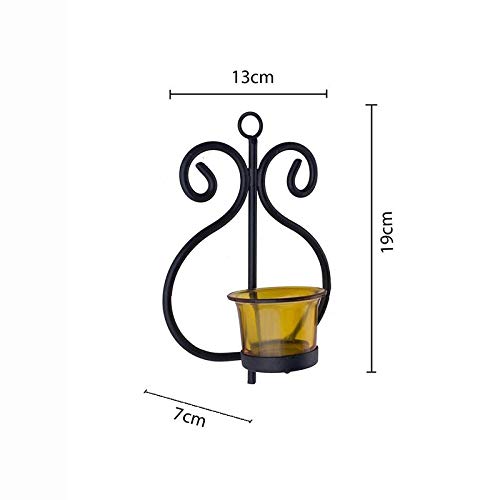 A black metal candle holder with a yellow candle.