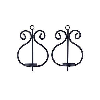 Black metal candle holders adorned with lovely scroll patterns.