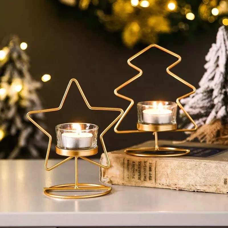 Two shiny gold star candles displayed on a table.