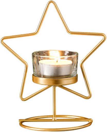  Two decorative star-shaped candles in gold on a table.