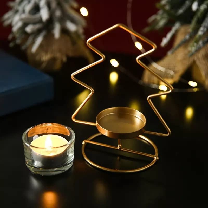 A pair of golden star-shaped candles resting on a table.