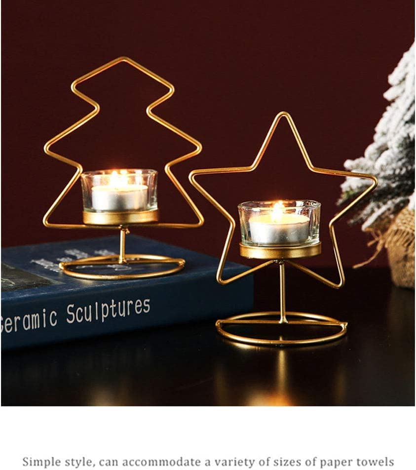 Two gold star-shaped candles on a table.