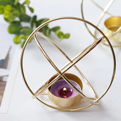 Gold metal tealight holder with purple candle on white background.