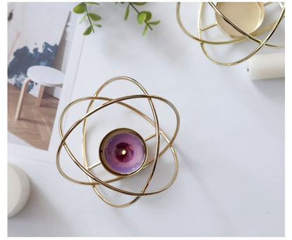 Elegant gold tealight holder with purple candle for cozy ambiance.