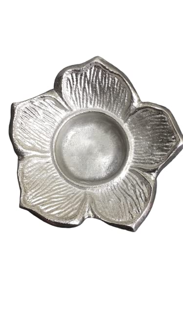 Silver dish in the shape of a flower against a white backdrop.