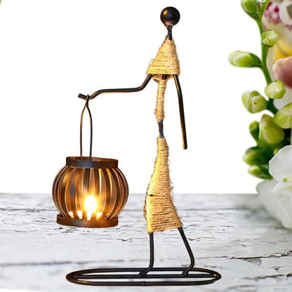 Decorative metal figure with candle and flower