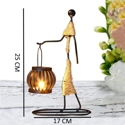 Metal statue with candle and flower