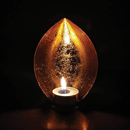 A golden candle in the shape of a leaf with a burning flame.