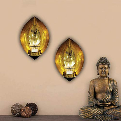 Two elegant gold leaf wall lights with candles, adding a touch of sophistication to any room decor.