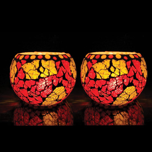 Two colorful glass tealights on black background.