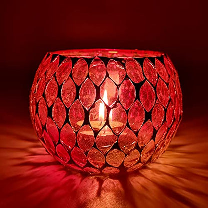  Red glass candle holder with glowing light inside.