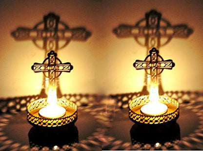 Cross-shaped arrangement of two burning candles.