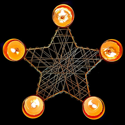 A star-shaped candle holder with five candles illuminated.