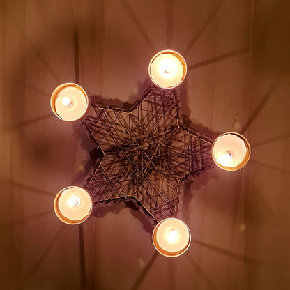 Candle holder shaped like a star with five candles.