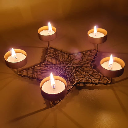 A beautiful star-shaped candle holder with four candles, creating a peaceful ambiance.