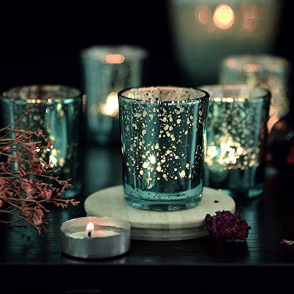 Elegant teal glass candle holder with burning candles and plate