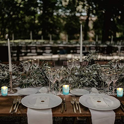 Decorative teal glass candle holder with candles and plate