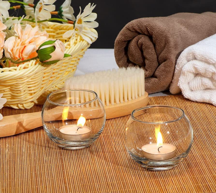 Glass bowl holding a burning candle, illuminating the room.