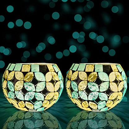 Elegant gold and green glass tea lights illuminating a table.