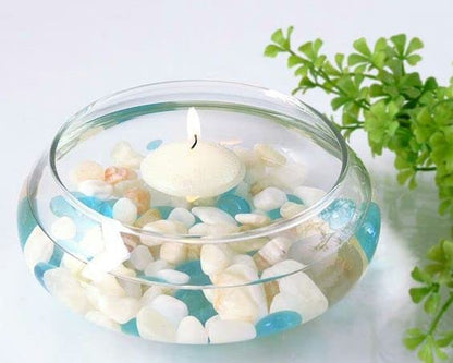 Decorative bowl filled with seashells and candles, perfect for a beach-themed decor.