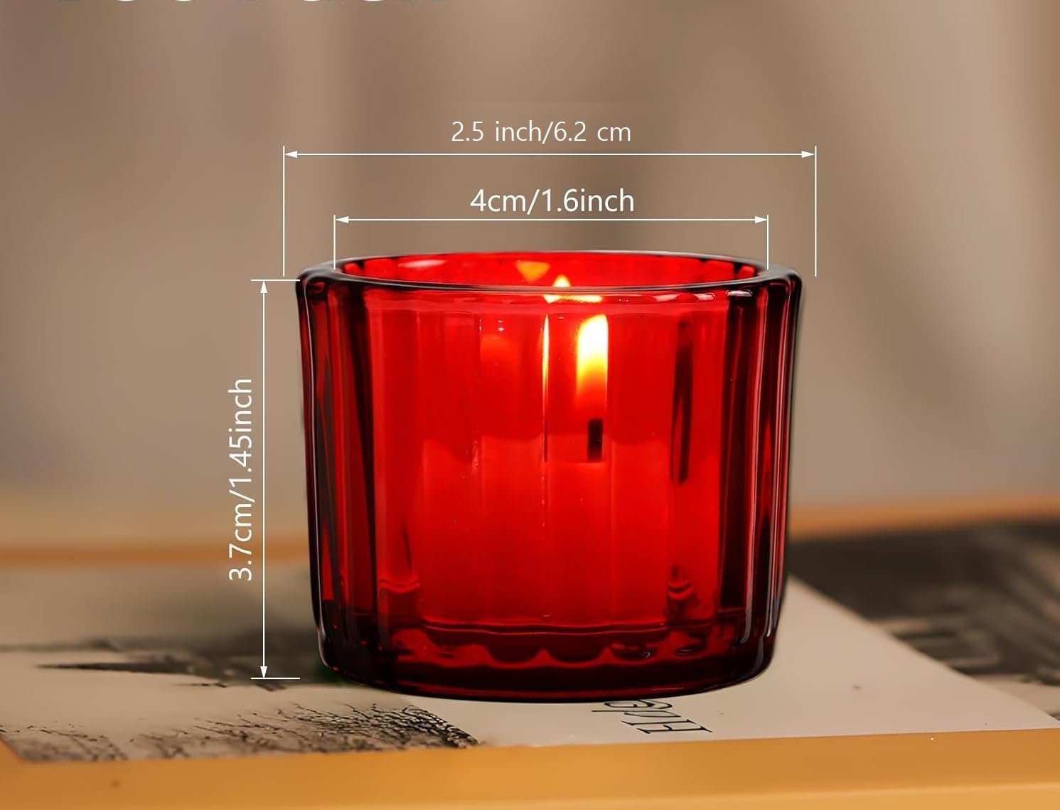 Red glass candle holder with dimensions on a neutral background