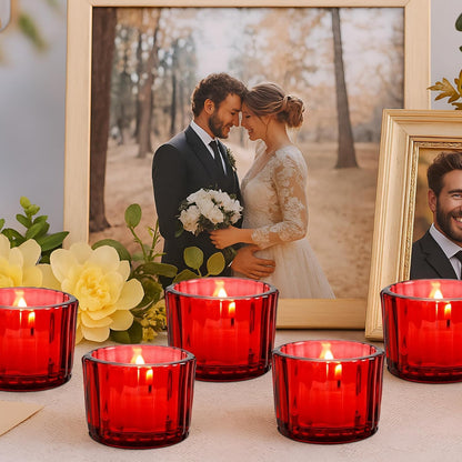 Red candles on a table with framed photos of a couple in the background