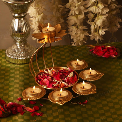  A gold candle holder with flowers and lit candles, creating a warm and elegant ambiance.