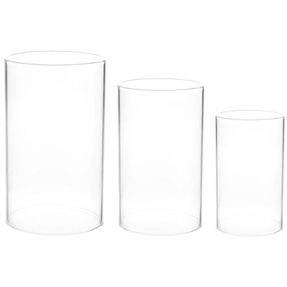 Glass candles and white flowers in the background.