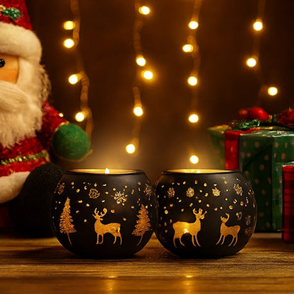 Two black candle holders with gold reindeer designs on a wooden surface with Christmas decorations in the background.