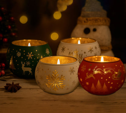 Four decorated candle holders with lit candles on a wooden surface, with a blurred Christmas tree and snowman in the background.