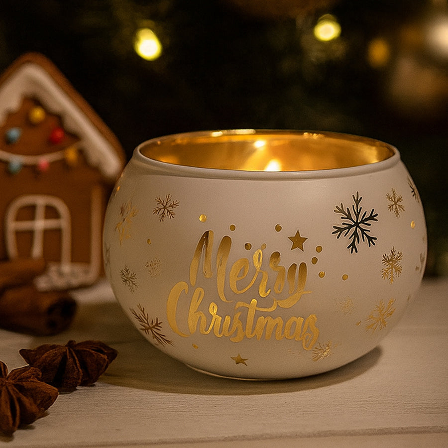 Decorative candle holder with 'Merry Christmas' text and gold interior, surrounded by festive items.