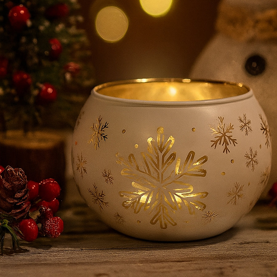 Decorative candle holder with gold snowflake patterns on a wooden surface, Christmas-themed background.