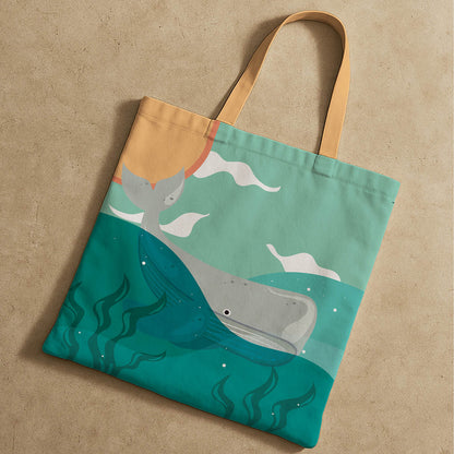 A tote bag displaying a whimsical whale alongside a bright sun, perfect for beach outings.
