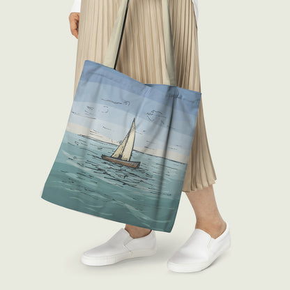 A woman holding a tote bag featuring a sailboat design, showcasing her love for sailing and nautical themes.