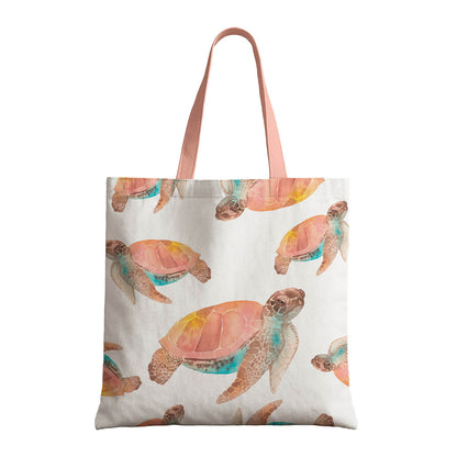 A tote bag displaying a charming watercolor turtle print against a pale backdrop.