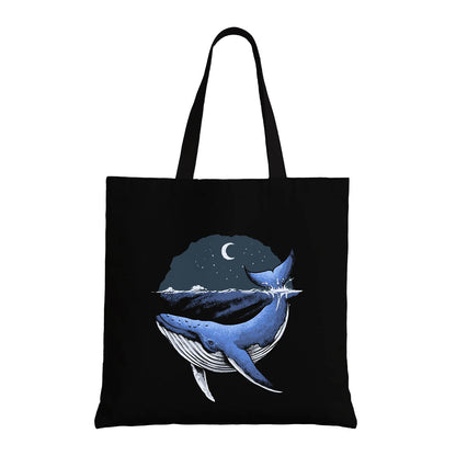 Stylish tote bag featuring a blue whale in the ocean, emphasizing marine conservation and oceanic beauty.