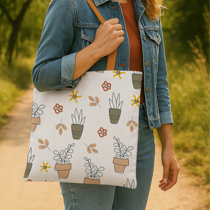 A stylish tote bag featuring an array of plants and flowers, perfect for eco-friendly shopping or casual outings.