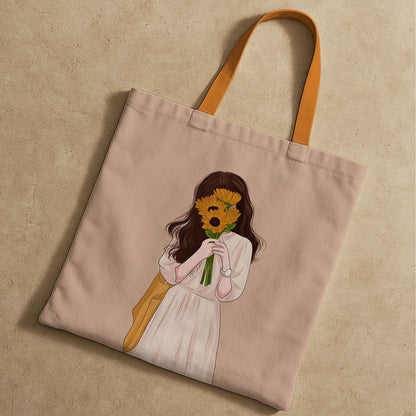 A tote bag displaying a sketch of a girl cheerfully holding a sunflower.
