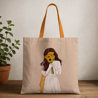A tote bag featuring a drawing of a girl joyfully holding a vibrant sunflower