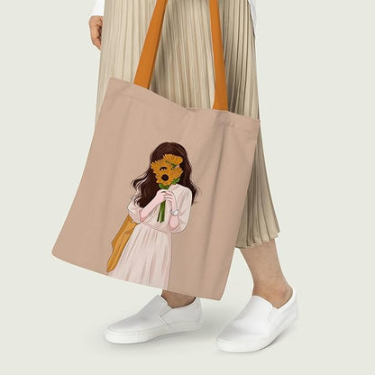 A tote bag with an artistic depiction of a girl holding a large sunflower.