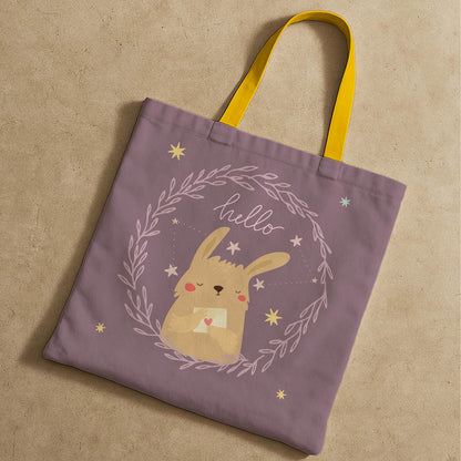 A tote bag displaying a friendly bunny and the text "hello" in a whimsical style.