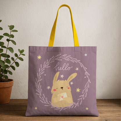 A tote bag featuring a cute bunny illustration and the word "hello" in playful font.