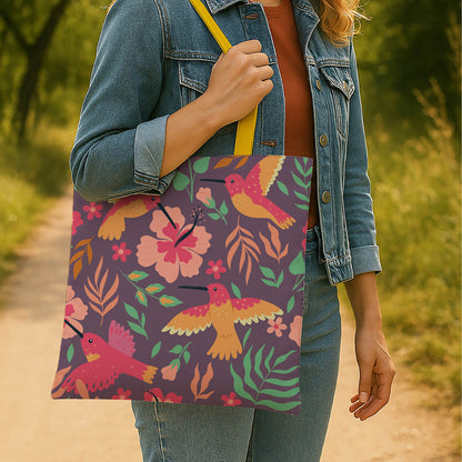 A stylish tote bag adorned with an array of colorful birds and blooming flowers, showcasing a lively pattern.